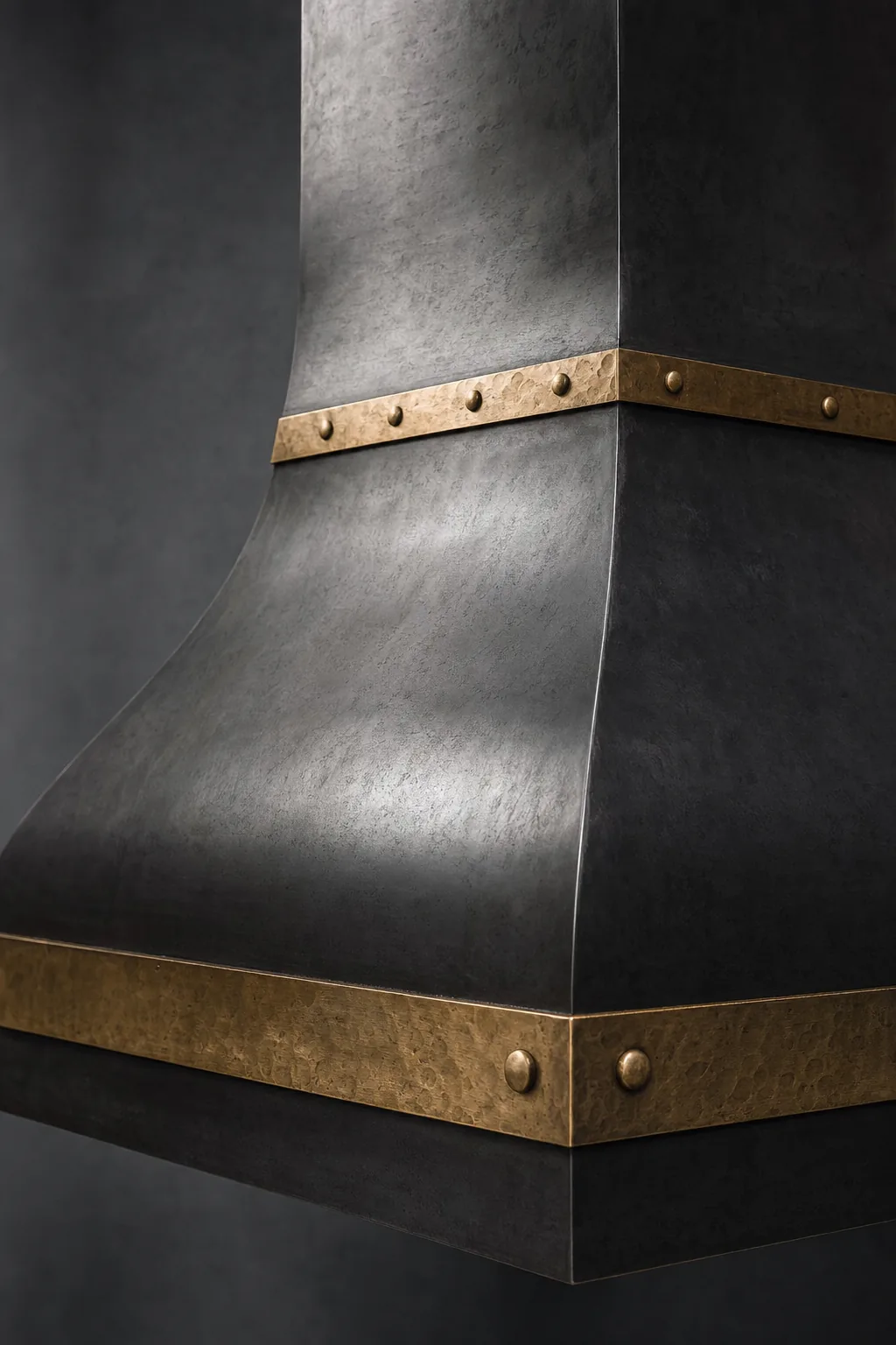 Blackened steel range hood with polished brass banding